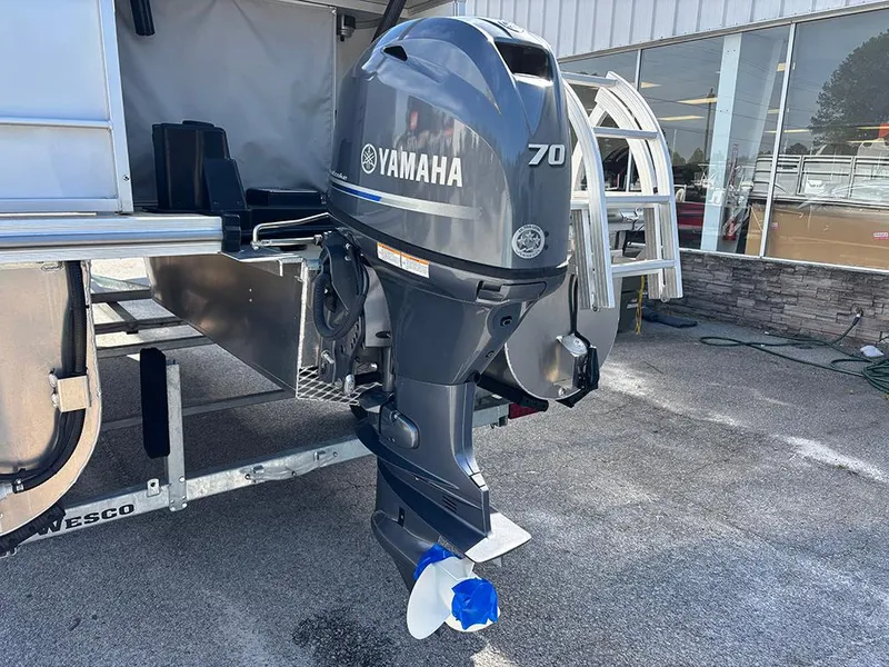 Slide: The Image of 2023 SunCatcher Select 18F with Yamaha 70 outboard motor, displayed outdoors. - 18