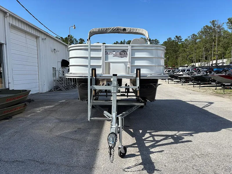 Slide: The Image of 2023 SunCatcher Select 18F pontoon boat on trailer, parked outdoors. - 4