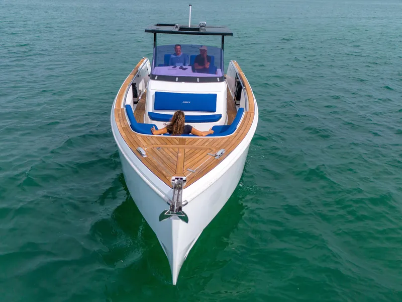 Slide: The Image of 2019 Fjord 38 boat cruising on clear blue water with passengers relaxing. - 33