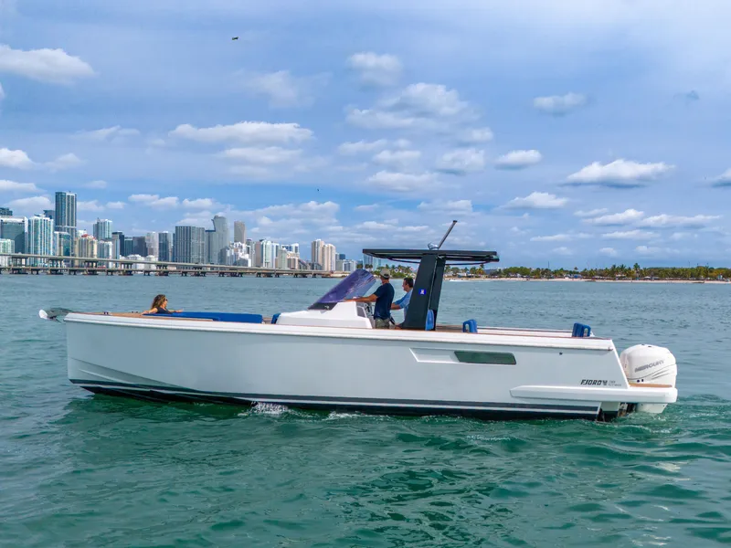 Slide: The Image of 2019 Fjord 38 boat cruising near city skyline under blue sky. - 43