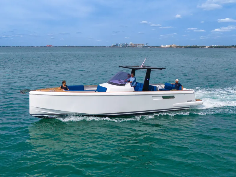 Slide: The Image of 2019 Fjord 38 motor yacht cruising on open water with passengers onboard. - 44