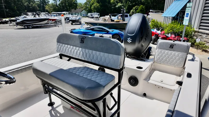 Slide: The Image of 2025 Carolina Skiff 21 LS Stealth Edition boat interior with seating and Suzuki outboard motor. - 11