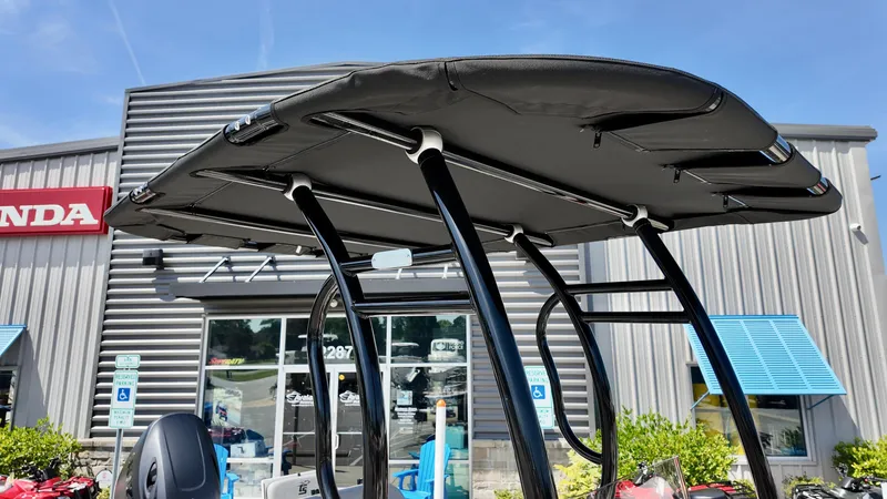 Slide: The Image of 2025 Carolina Skiff 21 LS Stealth Edition boat with T-top, outside dealership. - 7