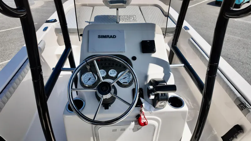 Slide: The Image of 2025 Carolina Skiff 21 LS Stealth Edition boat console with steering wheel and Simrad display. - 9