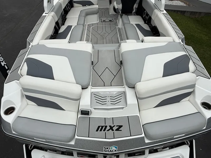 Slide: The Image of 2020 Malibu Wakesetter 24 MXZ boat interior with gray and white seating. - 10