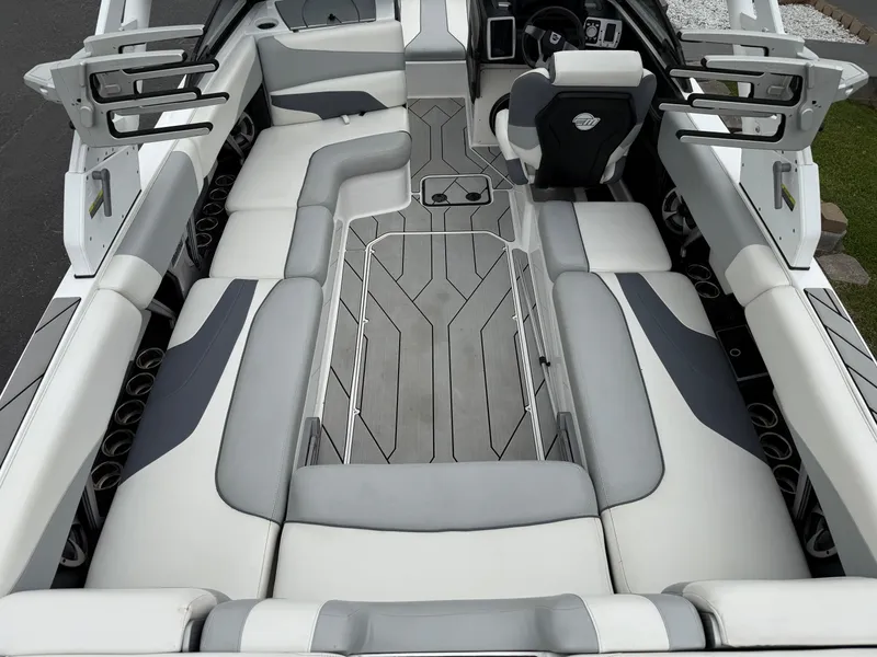 Slide: The Image of 2020 Malibu Wakesetter 24 MXZ interior with sleek gray and white seating design. - 12