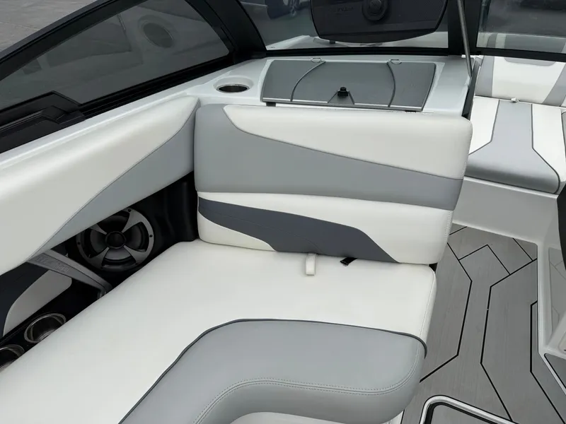 Slide: The Image of 2020 Malibu Wakesetter 24 MXZ interior with sleek white and gray seating design. - 15