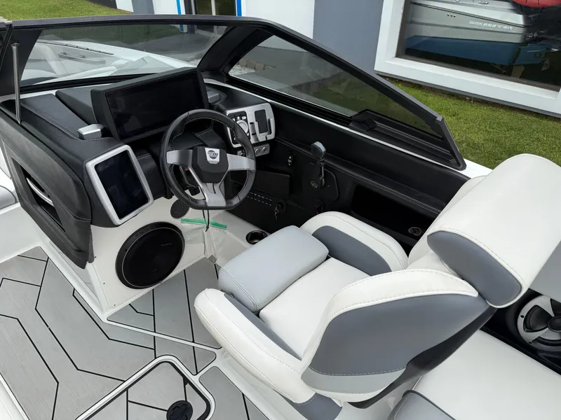 Slide: The Image of 2020 Malibu Wakesetter 24 MXZ interior with modern dashboard and comfortable seating. - 16