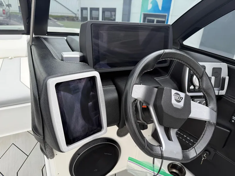 Slide: The Image of 2020 Malibu Wakesetter 24 MXZ dashboard with modern steering wheel and digital displays. - 17