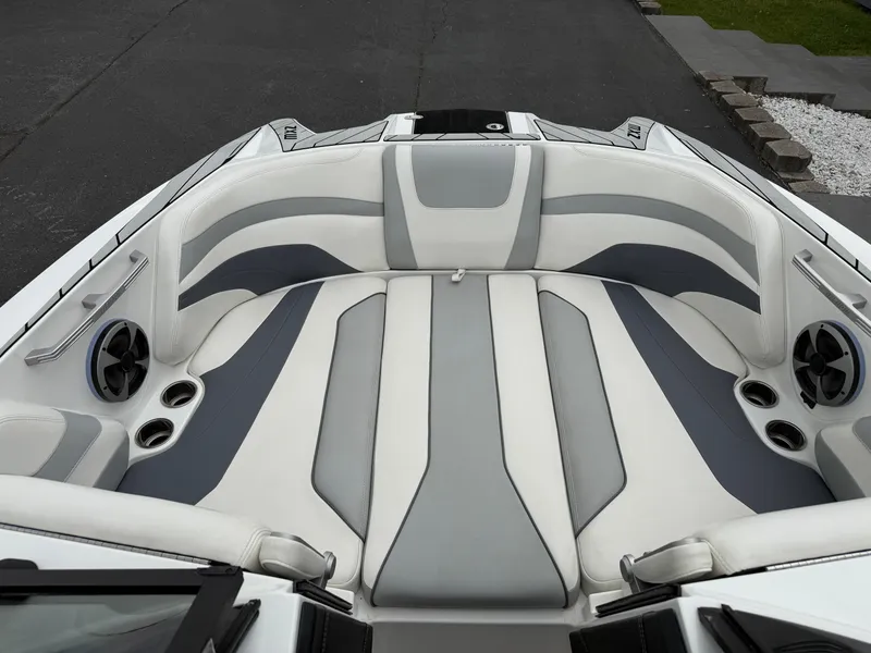Slide: The Image of 2020 Malibu Wakesetter 24 MXZ boat interior with gray and white seating. - 19