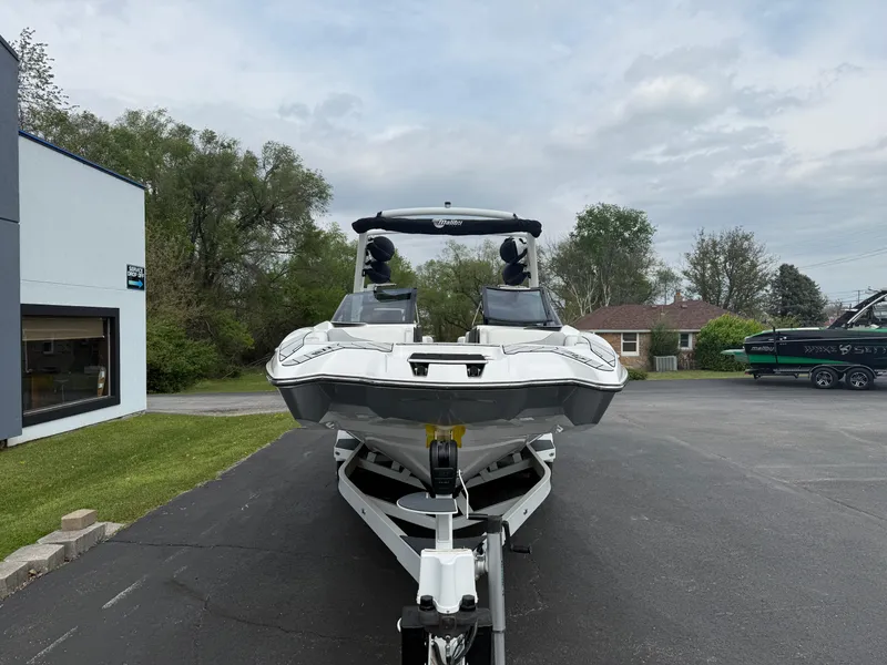 Slide: The Image of 2020 Malibu Wakesetter 24 MXZ boat on trailer, parked outdoors. - 2