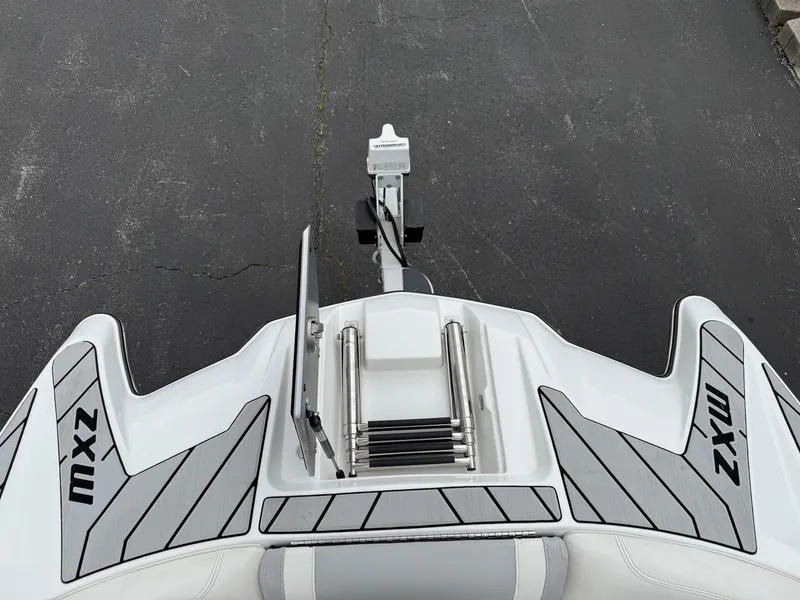 Slide: The Image of 2020 Malibu Wakesetter 24 MXZ boat stern with ladder and MXZ branding. - 23