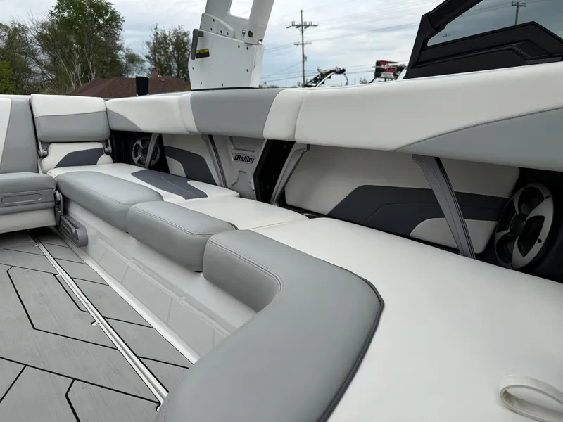 Slide: The Image of 2020 Malibu Wakesetter 24 MXZ interior with gray and white seating, modern design. - 26