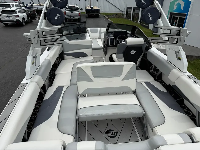 Slide: The Image of 2020 Malibu Wakesetter 24 MXZ interior with sleek seating and modern dashboard. - 29