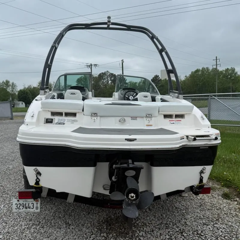 Slide: The Image of 2017 Chaparral H20 19 Sport boat, rear view, parked on gravel. - 2
