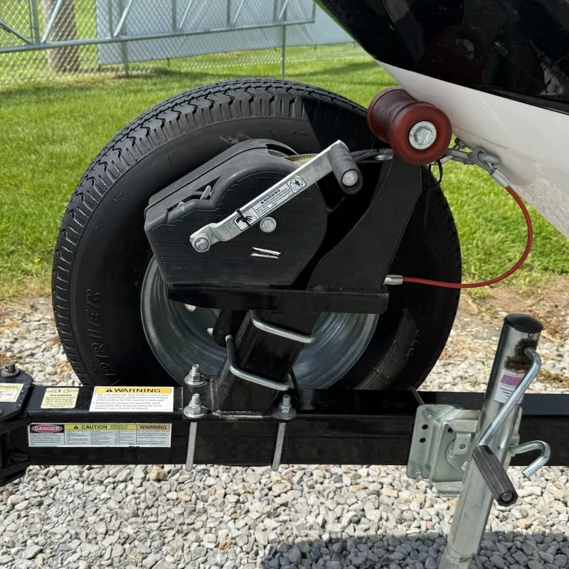 Slide: The Image of Trailer wheel and winch of 2017 Chaparral H20 19 Sport on gravel. - 5