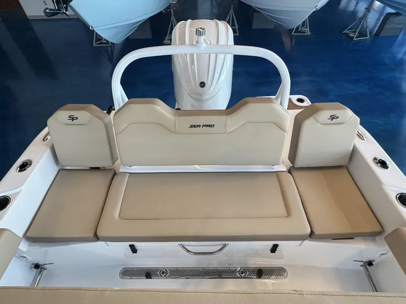 Slide: The Image of 2025 Sea Pro 225 FLX boat interior with beige seating and white accents. - 11