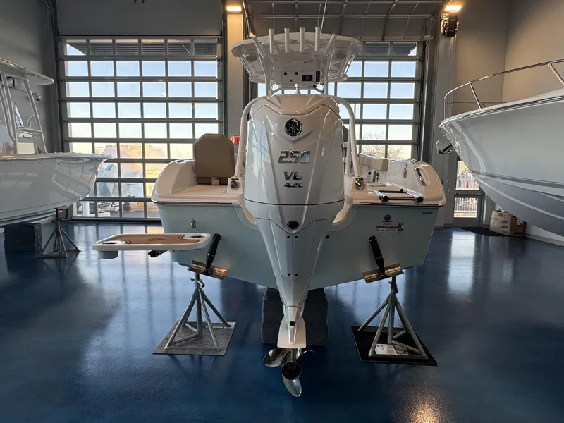 Slide: The Image of 2025 Sea Pro 225 FLX boat displayed in showroom, rear view. - 12