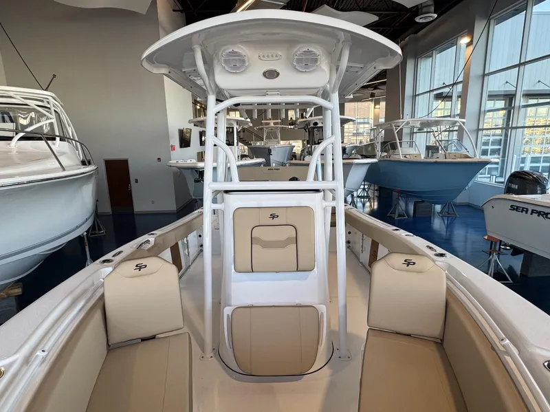 Slide: The Image of 2025 Sea Pro 225 FLX boat interior, featuring spacious seating and modern design in a showroom. - 4