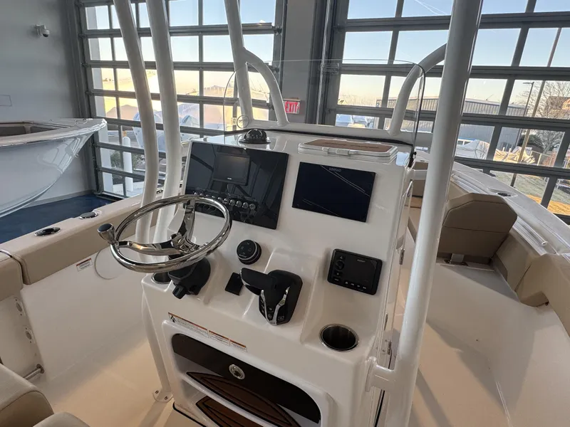Slide: The Image of 2025 Sea Pro 225 FLX boat interior with modern dashboard and steering wheel. - 6