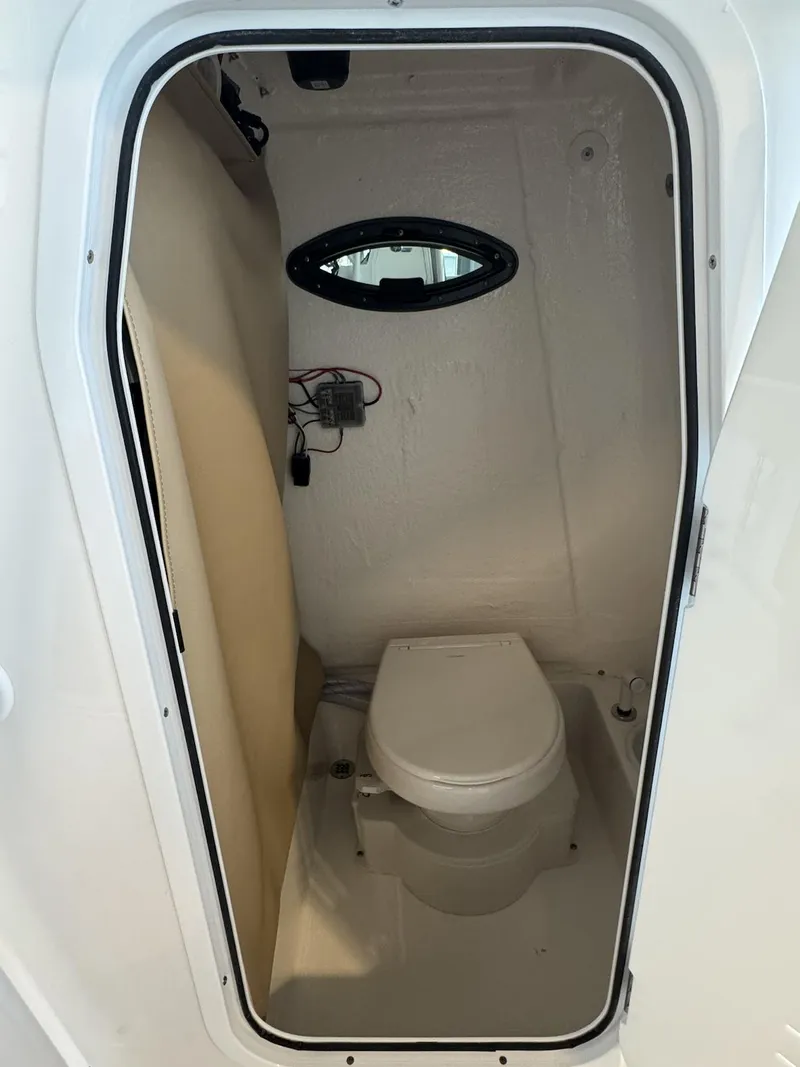 Slide: The Image of 2025 Sea Pro 225 FLX boat interior with compact marine toilet. - 9