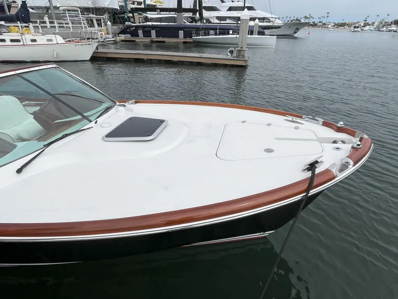 Slide: The Image of 2007 Hinckley Talaria 29 R boat docked in a marina, showcasing sleek design and craftsmanship. - 14