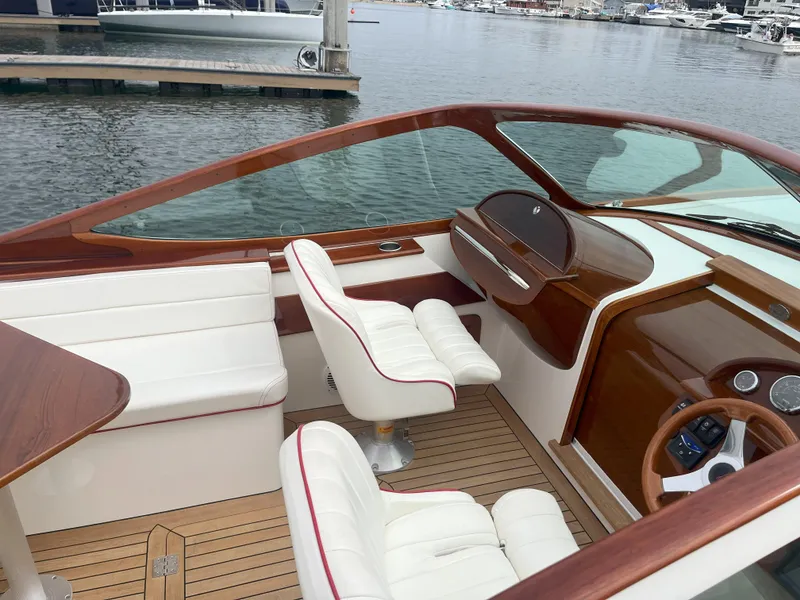 Slide: The Image of 2007 Hinckley Talaria 29 R boat interior with elegant wood and white leather seating. - 23