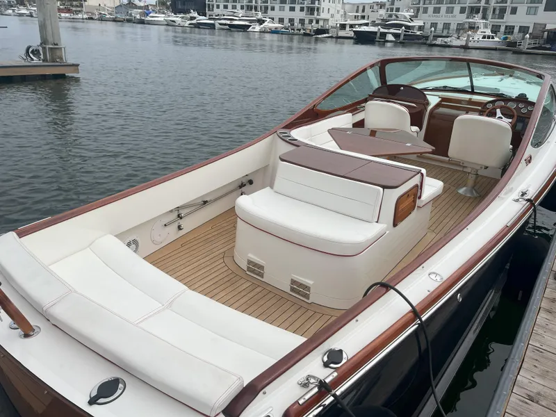 Slide: The Image of 2007 Hinckley Talaria 29 R boat with elegant seating, docked in a marina. - 25