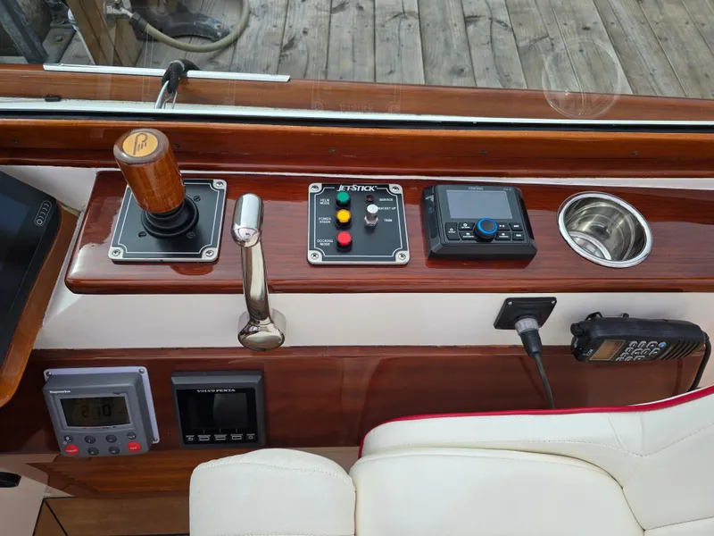 Slide: The Image of Control panel of a 2007 Hinckley Talaria 29 R boat with joystick and navigation equipment. - 28