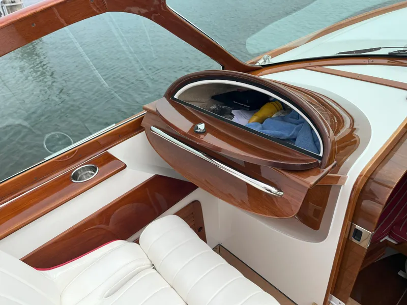 Slide: The Image of 2007 Hinckley Talaria 29 R interior with wooden dashboard and white leather seating. - 36