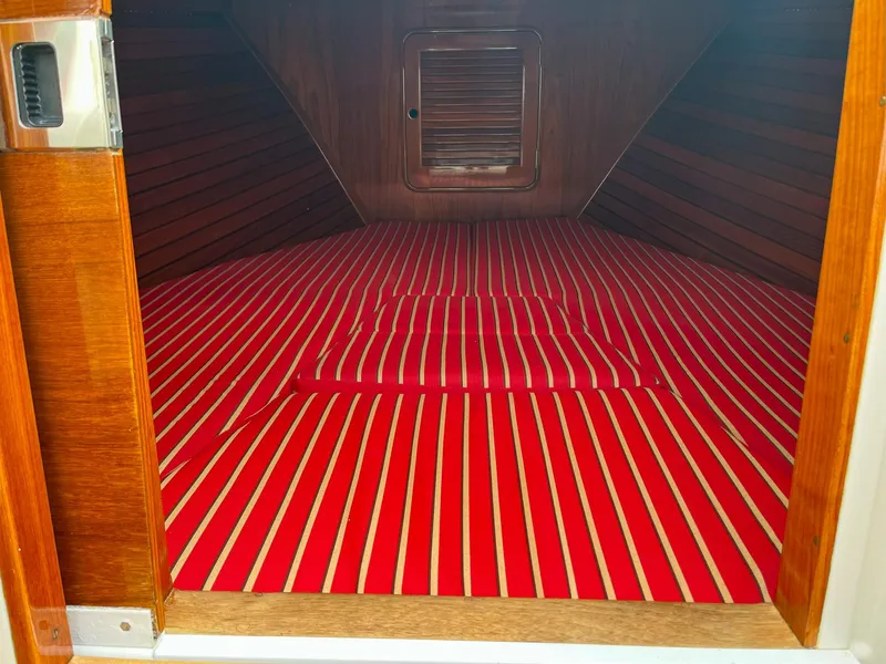 Slide: The Image of Interior cabin of 2007 Hinckley Talaria 29 R with red striped flooring. - 39