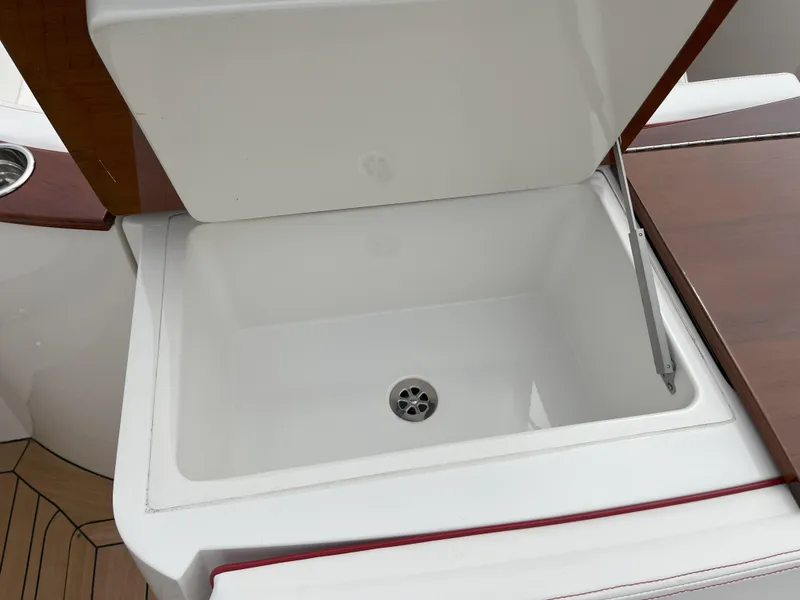 Slide: The Image of Open storage compartment on 2007 Hinckley Talaria 29 R boat with drain. - 45