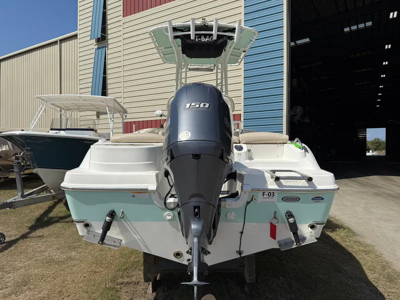 Slide: The Image of 2016 NauticStar 2102 Legacy boat with 150 HP engine, parked outside a storage facility. - 12