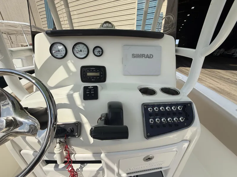 Slide: The Image of 2016 NauticStar 2102 Legacy boat dashboard with gauges and Simrad electronics. - 6