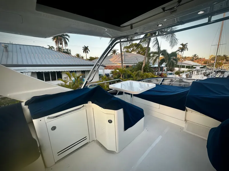 Slide: The Image of Flybridge of 2015 Sea Ray 510 Fly yacht with covered seating and table. - 16