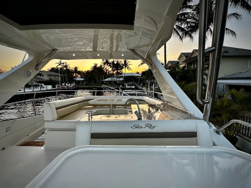 Slide: The Image of Luxurious 2015 Sea Ray 510 Fly yacht interior at sunset, featuring elegant seating and waterfront views. - 17