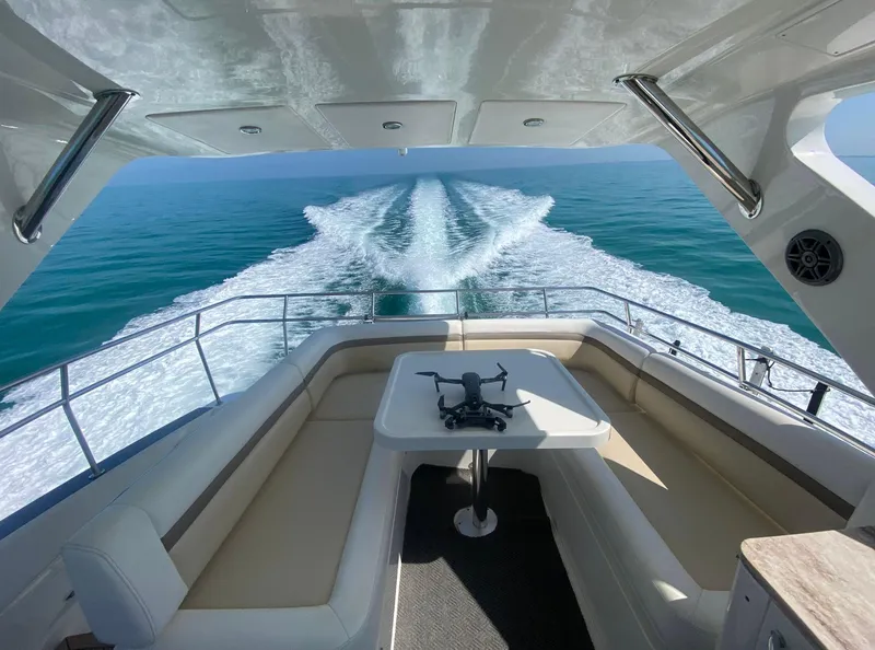 Slide: The Image of 2015 Sea Ray 510 Fly yacht cruising on open water, view from the deck. - 22