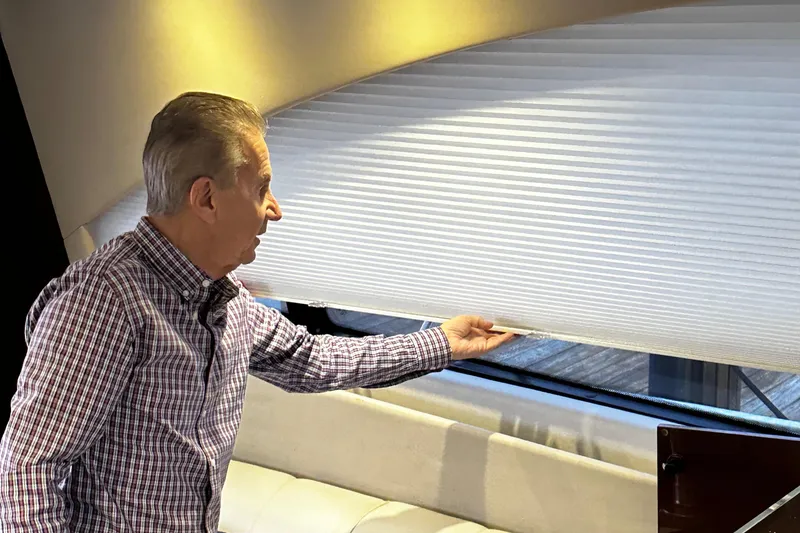 Slide: The Image of Man adjusting window blind inside 2015 Sea Ray 510 Fly yacht. - 28