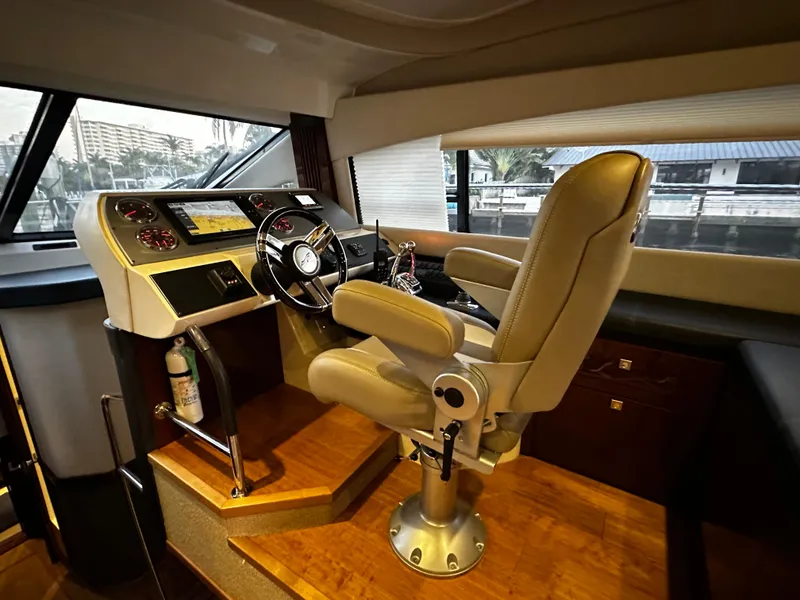 Slide: The Image of Helm station of 2015 Sea Ray 510 Fly yacht with captain's chair and navigation controls. - 30