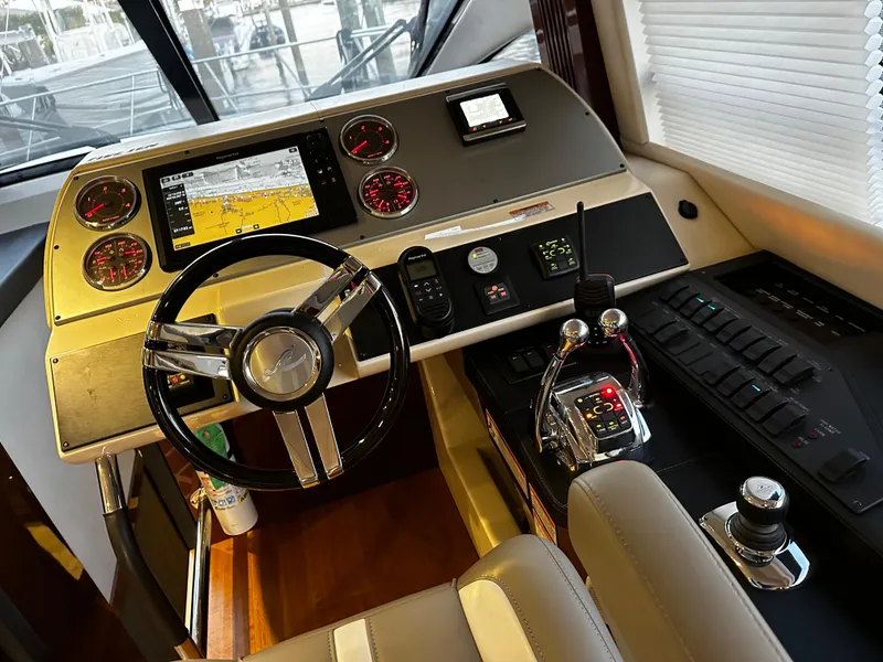 Slide: The Image of Cockpit of 2015 Sea Ray 510 Fly yacht with modern navigation controls and steering wheel. - 32
