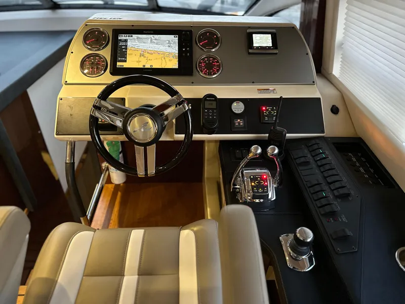 Slide: The Image of Helm of 2015 Sea Ray 510 Fly yacht with modern navigation controls and steering wheel. - 33