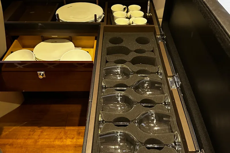 Slide: The Image of Storage drawers with plates, cups, and wine glasses on a 2015 Sea Ray 510 Fly yacht. - 37