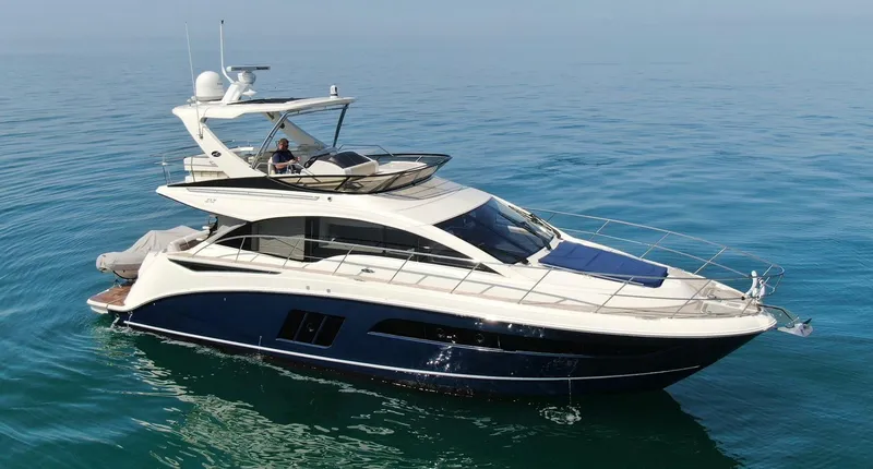 Slide: The Image of 2015 Sea Ray 510 Fly yacht cruising on calm blue waters. - 4