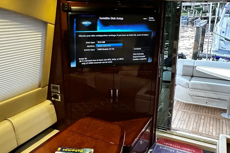Slide: The Image of Interior of 2015 Sea Ray 510 Fly yacht with satellite TV setup and marina view. - 46