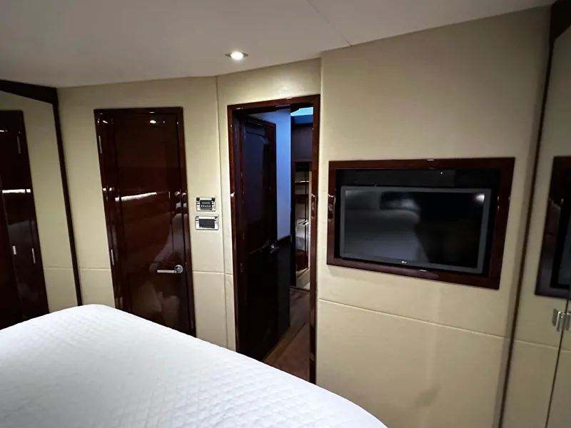 Slide: The Image of Luxurious interior of 2015 Sea Ray 510 Fly yacht with TV and wooden doors. - 48