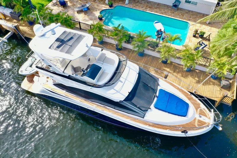 Slide: The Image of Aerial view of 2015 Sea Ray 510 Fly yacht docked near a poolside deck. - 7
