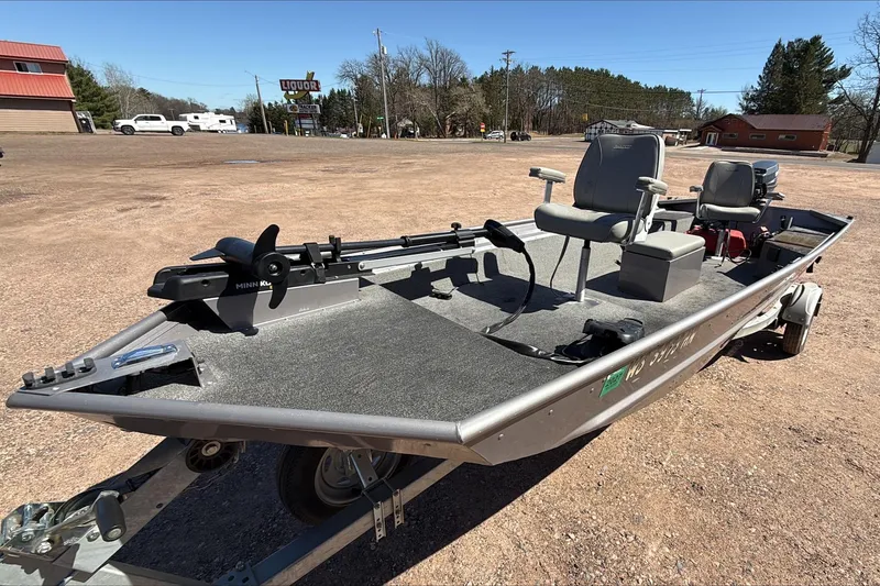 Slide: The Image of 2008 Alumacraft Crappie Deluxe fishing boat on trailer in parking lot. - 1