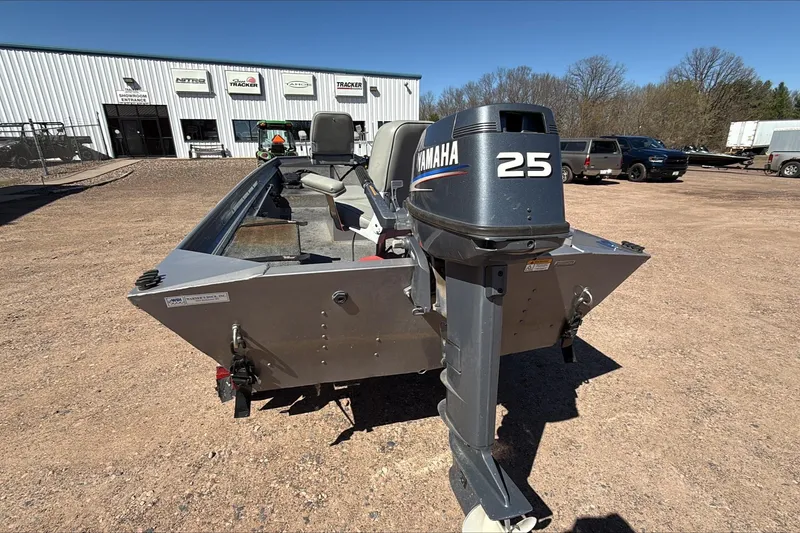 Slide: The Image of 2008 Alumacraft Crappie Deluxe boat with Yamaha 25 outboard motor in a sunny outdoor setting. - 2