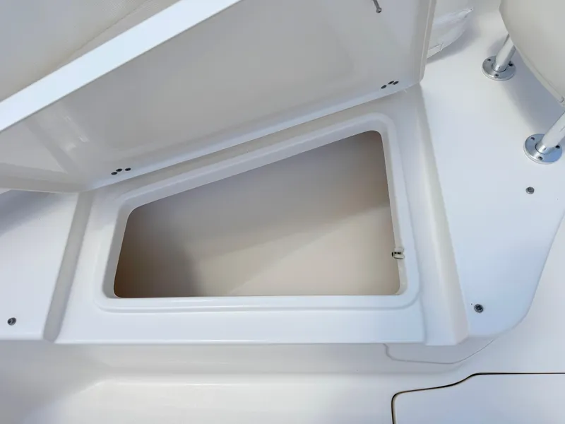 Slide: The Image of Open storage compartment on 2017 Key West 244 Center Console boat. - 15