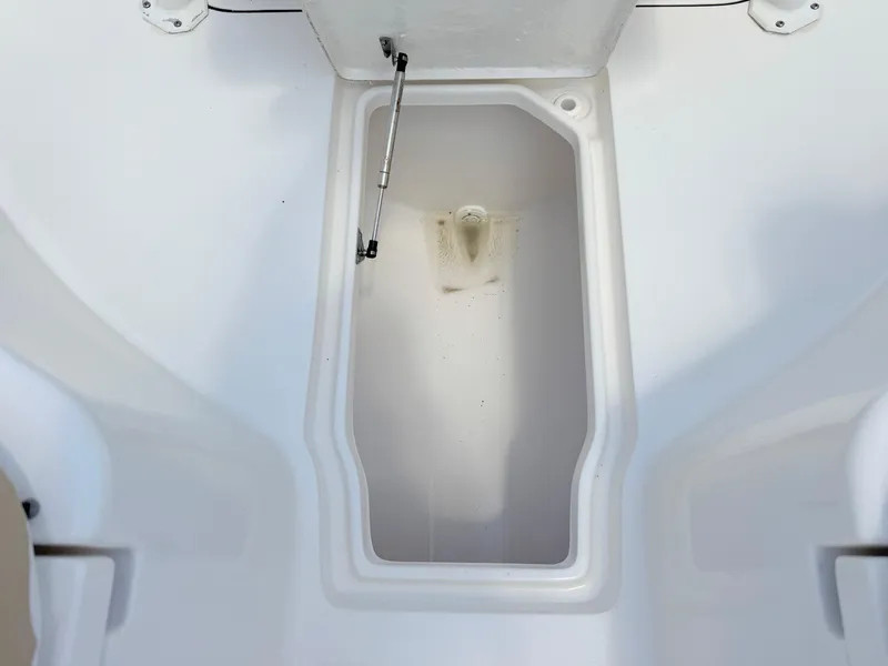 Slide: The Image of Open storage compartment on 2017 Key West 244 Center Console boat. - 16